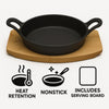 REGENT COOKWARE CAST IRON PAN WITH 2 HANDLES ON A WOODEN BOARD, (250X180X79MM)