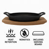 REGENT COOKWARE CAST IRON OVAL PAN WITH 2 HANDLES ON A WOODEN BOARD, 225X120MM