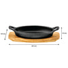 REGENT COOKWARE CAST IRON OVAL PAN WITH 2 HANDLES ON A WOODEN BOARD, 225X120MM