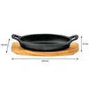 REGENT COOKWARE CAST IRON OVAL PAN WITH 2 HANDLES ON A WOODEN BOARD, (225X120X55MM)