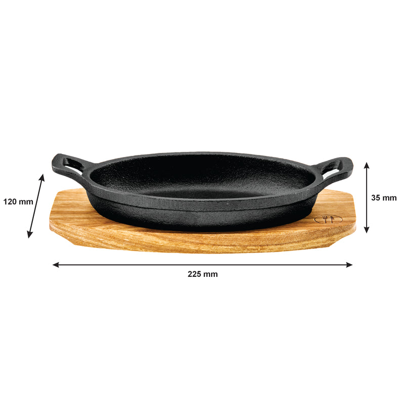REGENT COOKWARE CAST IRON OVAL PAN WITH 2 HANDLES ON A WOODEN BOARD, (225X120X55MM)