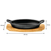 REGENT COOKWARE CAST IRON OVAL PAN WITH 2 HANDLES ON A WOODEN BOARD, (225X120X55MM)