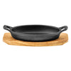REGENT COOKWARE CAST IRON OVAL PAN WITH 2 HANDLES ON A WOODEN BOARD, 225X120MM